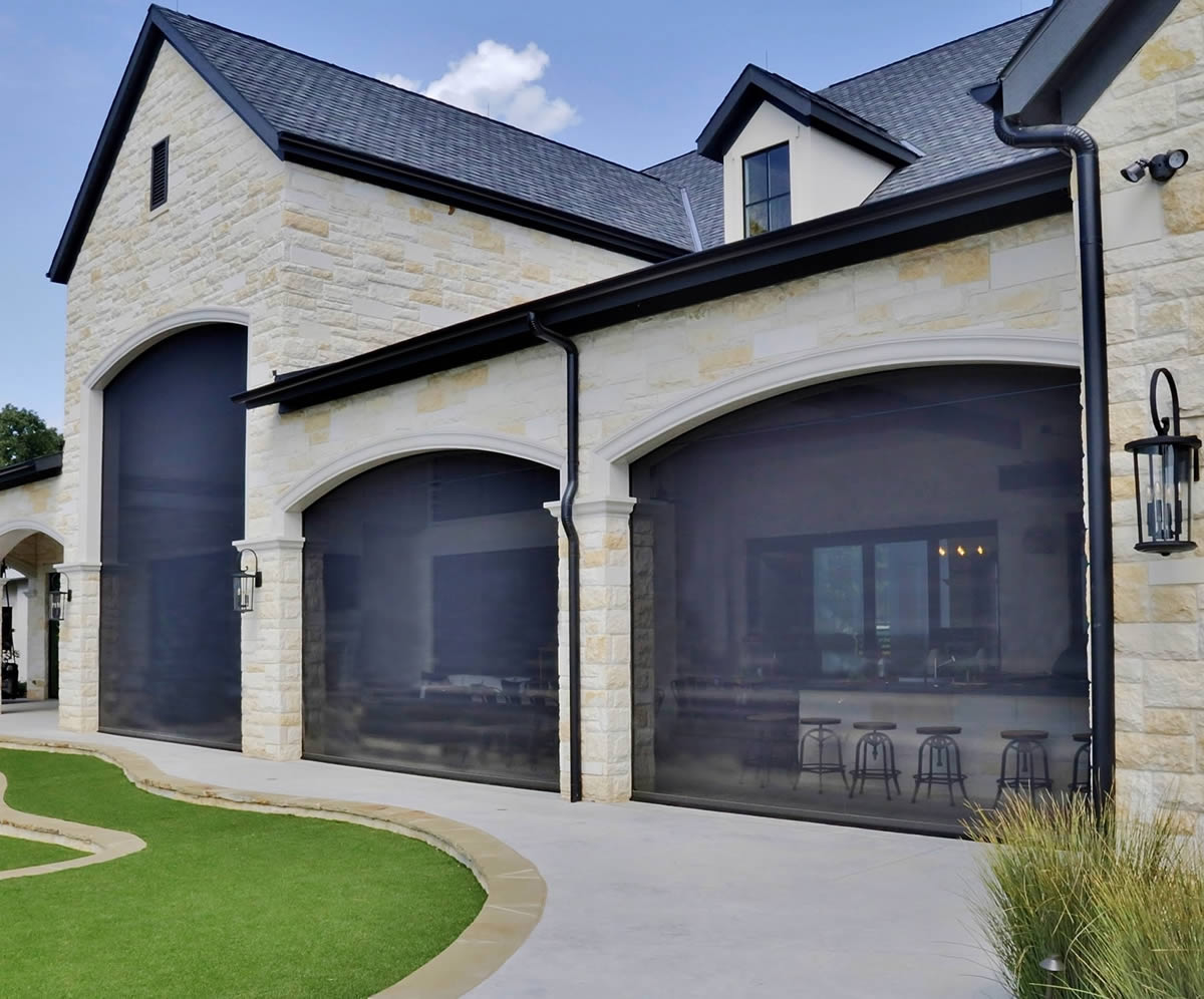 Motorized retractable screens for patios, porches, and large openings
